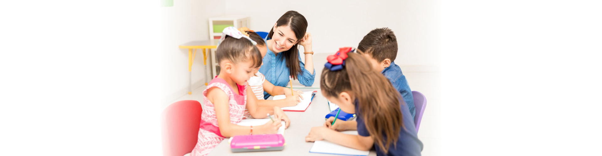 teacher helping her students