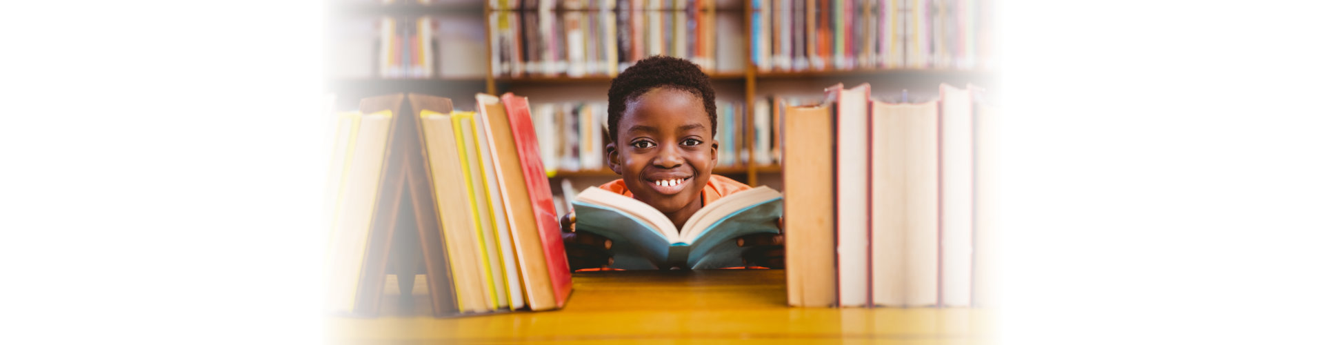 young boy at library smiling